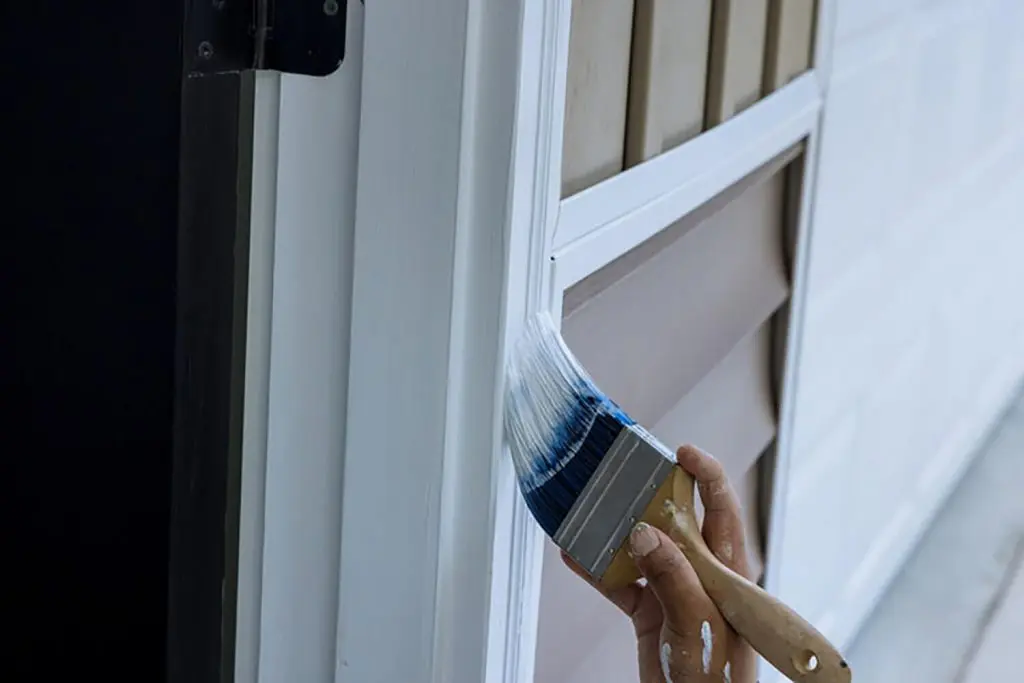 Freshly painted white door trim receiving a smooth finish coat from an angled brush in Chesterland, OH